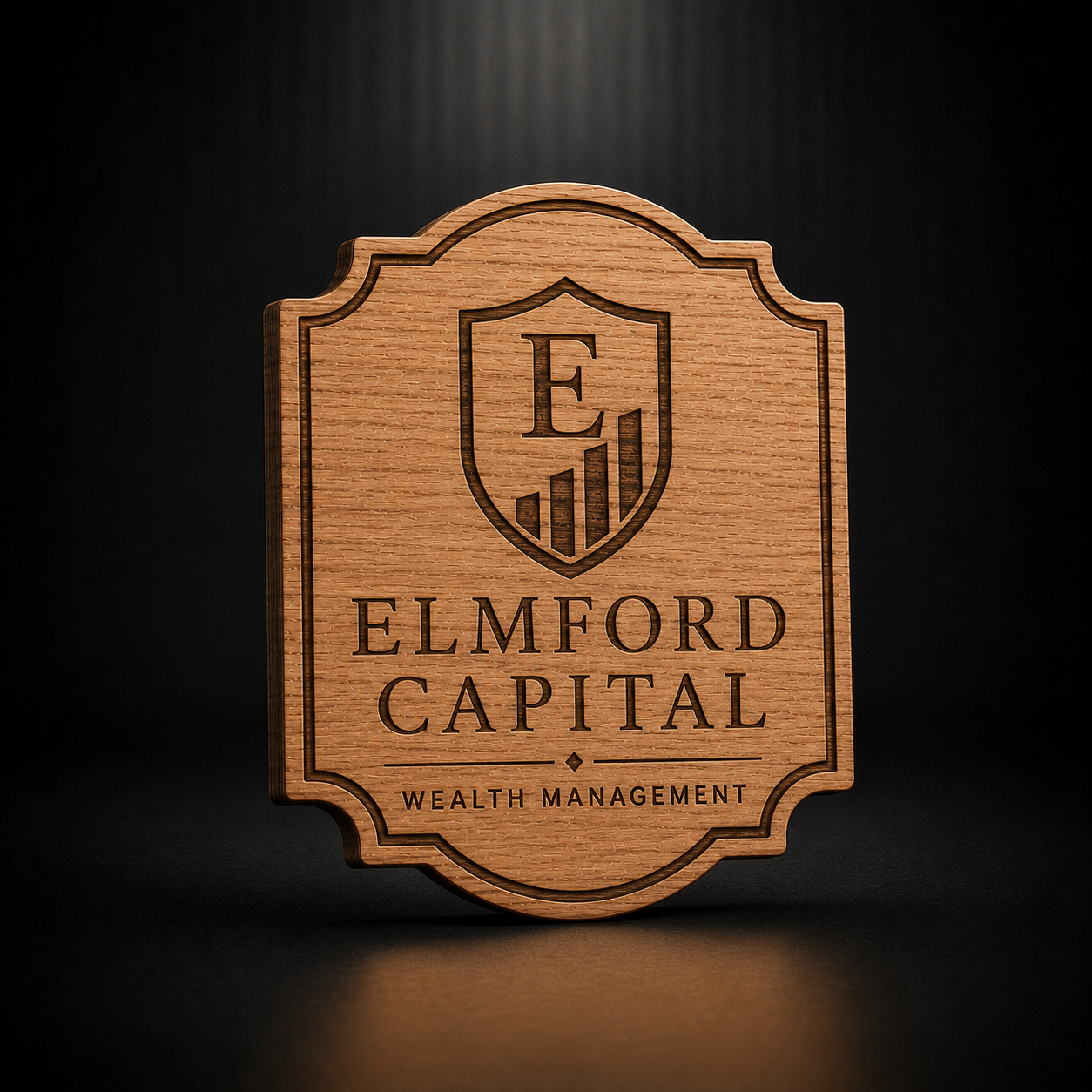 A rectangular wooden plaque with rounded corners and a decorative border, featuring a shield logo with the letter E and the engraved text 'ELMFORD CAPITAL' and 'WEALTH MANAGEMENT' on a dark background.