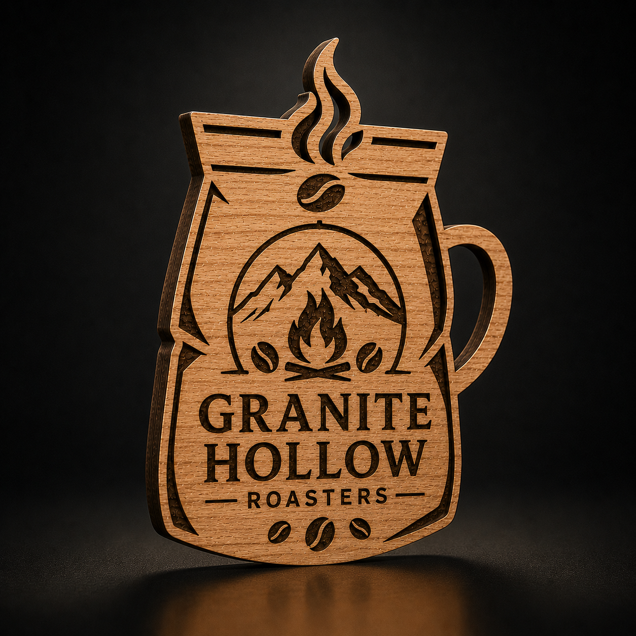 A laser-cut wooden coffee bag ornament featuring the engraved logo for Granite Hollow Roasters, displayed on a dark reflective surface.